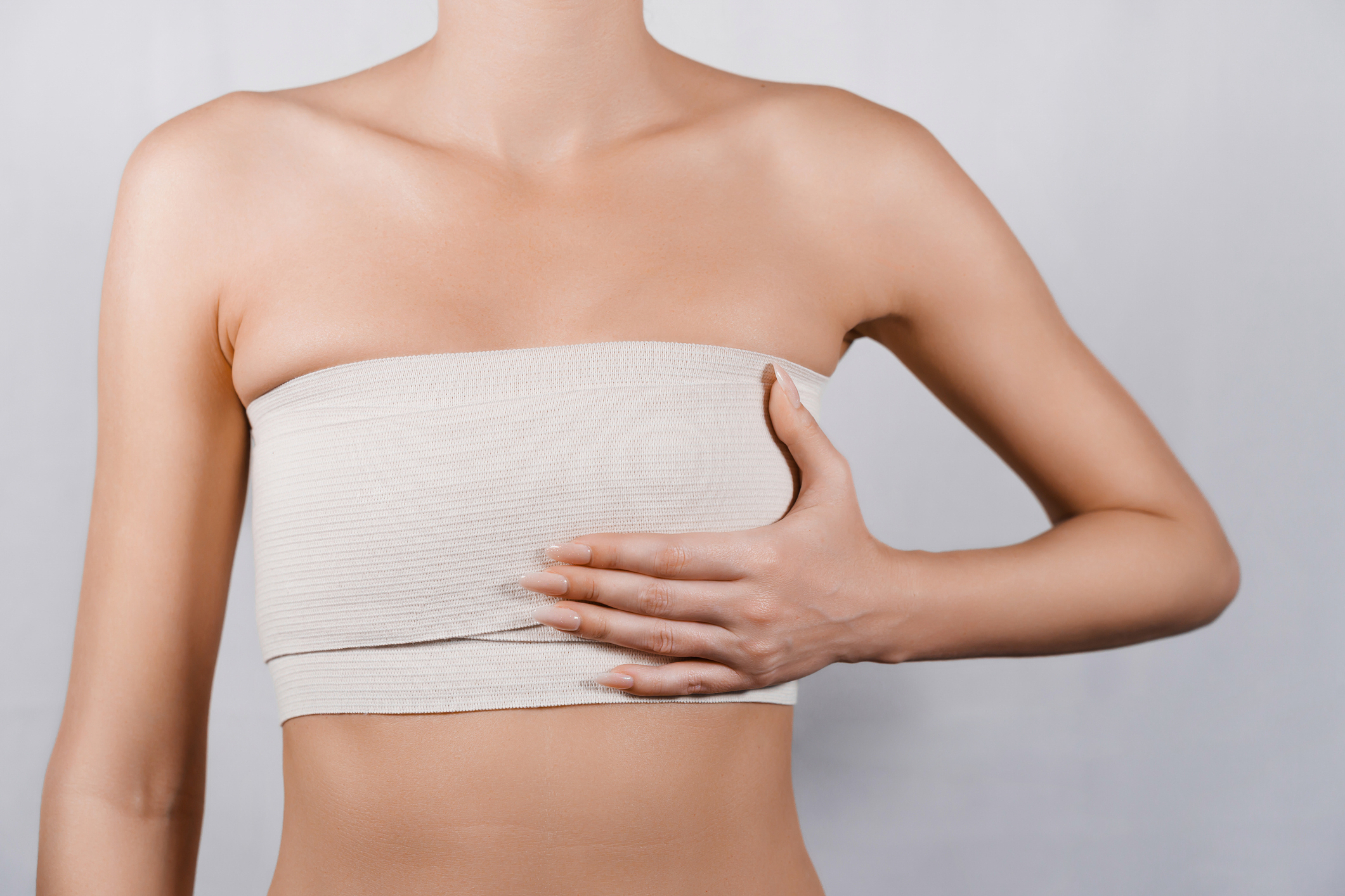 woman holding breast