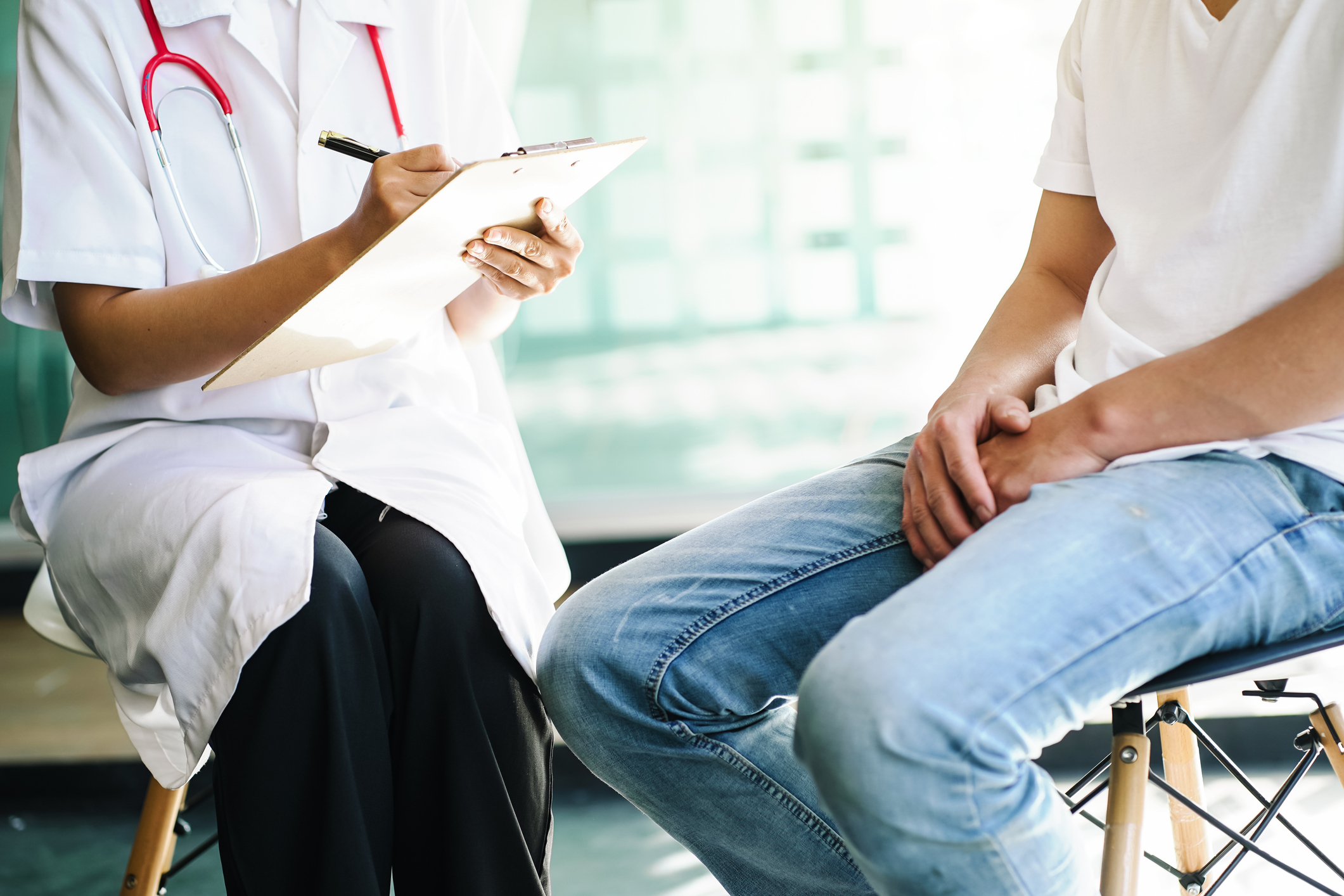 worker talking to male patient